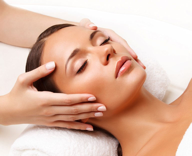face massage. close up of a young woman getting spa treatment.
